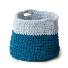 a blue and white crocheted basket on a white background