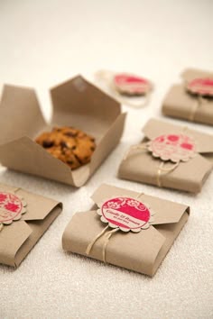 some brown paper boxes with cookies in them