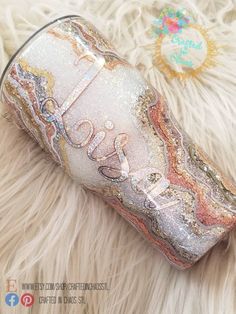 a close up of a can on a furry surface with the word love written in it