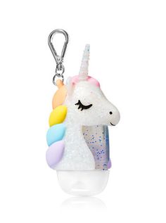 a keychain with a unicorn on it's face and a rainbow horn