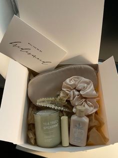 an open gift box containing two bottles of tea tree spearmint and body lotion