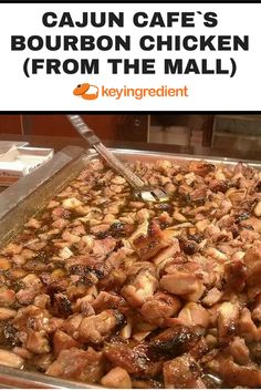 a pan filled with chicken and sauce on top of a counter next to a sign that says cajun cafe's bourbon chicken from the mall