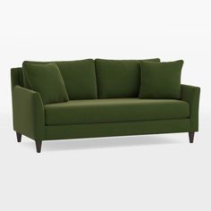 a green couch sitting on top of a white floor