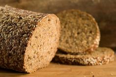 two loaves of bread sitting on top of a wooden table