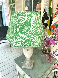 a green lamp sitting on top of a table