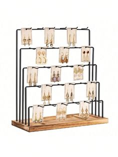 a wooden and metal rack with earrings on it