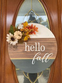 a wooden sign that says hello fall with flowers on it and the words hello fall written in white