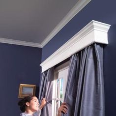 the corner of a room with blue walls and curtains