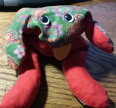 an elephant stuffed animal sitting on top of a wooden table