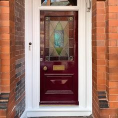 a red front door with stained glass on it