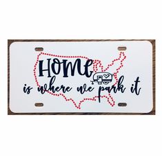 a white license plate with the words home is where we park it in red and black