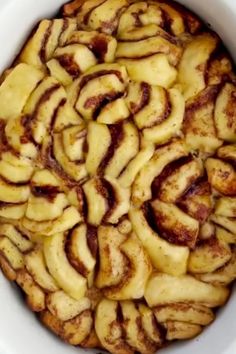 an apple pie with cinnamon swirl topping in a white bowl