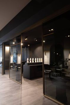 the inside of a salon with mirrors and lights