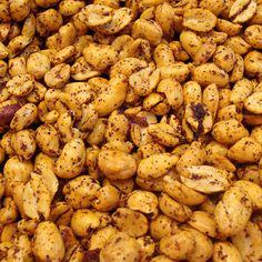 close up view of roasted peanuts with brown speckles