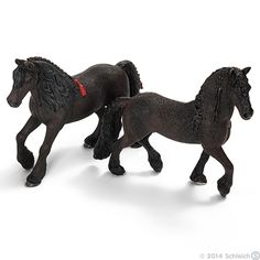 two black toy horses walking side by side