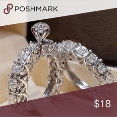 two wedding rings are on display with the price tag below them