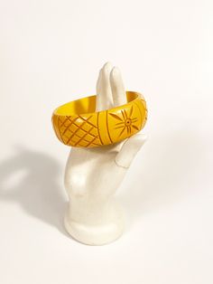 "1940s butterscotch yellow Bakelite bracelet with a carved design and lovely patina. Exterior Circumference: 9.5\" Width: 1\" Interior Diameter: 2.5\" Label: None. Condition: Excellent vintage condition. All vintage is sold in \"as-is\" condition. We do our best to inspect, correct, and list important flaws. All measurements are made with the garment laying flat. Length is measured from shoulder to hem unless otherwise noted. Questions? Send us a message! Please review our policies here: http:// Vintage Amber Bangle Bracelet, Vintage Amber Bangle Jewelry, Vintage Bakelite Bangle Jewelry, Vintage Bakelite Bangle, Vintage Carved Orange Jewelry, Vintage Carved Amber Jewelry, Vintage Amber Carved Jewelry, Vintage Orange Carved Jewelry, Orange Carved Vintage Jewelry