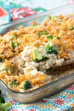 a casserole dish with broccoli and cheese on the side is ready to be eaten