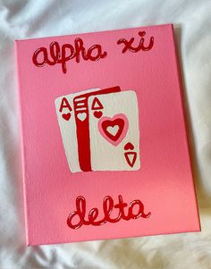 a pink canvas with the word delta written in red on it and an image of a deck of cards