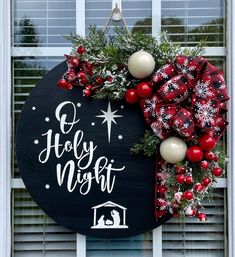 a christmas wreath hanging on the side of a window