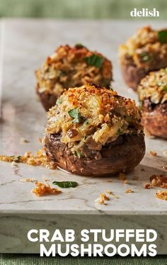 crab stuffed mushrooms on a baking sheet with parmesan crumbs