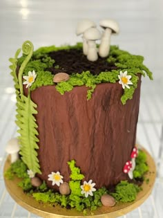 there is a cake with mushrooms and plants on it