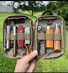 a person holding an open case filled with lots of different types of tools and gadgets