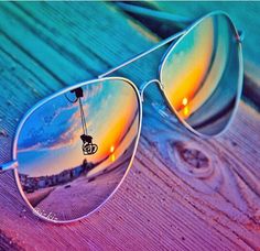 a pair of sunglasses sitting on top of a wooden table