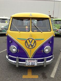 an old vw bus parked in a parking lot