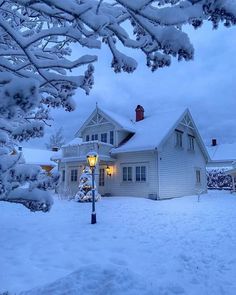 a white house with snow on the ground