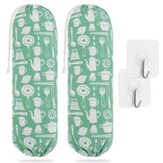 two green oven mitts with teapots and utensils printed on them