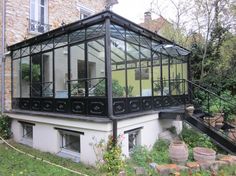 a glass house with stairs leading up to it