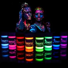 two people are standing next to each other with neon paint