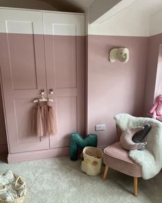 a baby's room with pink walls and white carpeted flooring is shown