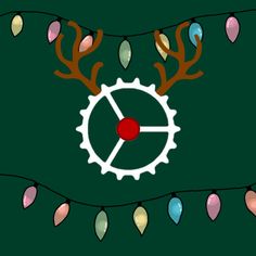 a clock with christmas lights around it on a green background that is decorated with deer antlers