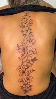 a woman's back with flowers on it