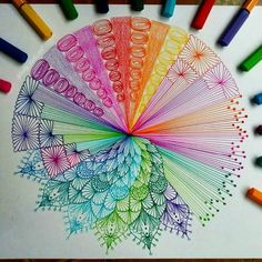 colored crayons are arranged in the shape of a fan