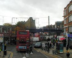 a red double decker bus driving down a street