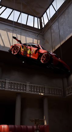 a car suspended from the ceiling in a building