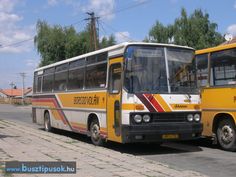 two buses parked next to each other on the street