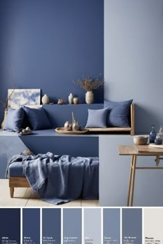 a room with blue walls and furniture in shades of gray, white, and blue