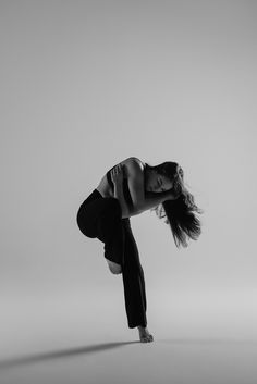 a woman is doing a handstand in the air