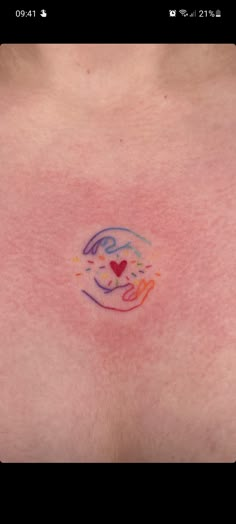 the breast is covered with colored ink and has a small heart on it's side