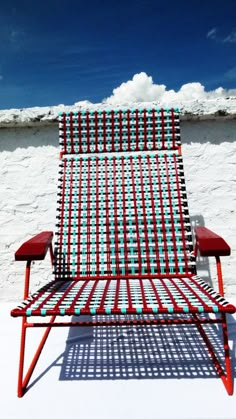 a red and white chair sitting on top of snow covered ground