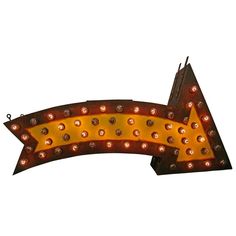 an arrow shaped light up sign with lights on it's sides and the bottom half pointing upward