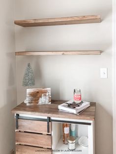 a shelf with some books on it and a christmas tree in the corner next to it