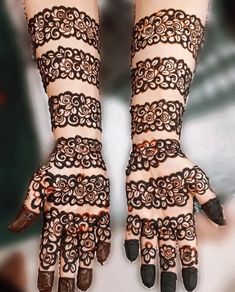 the hands are decorated with henna designs