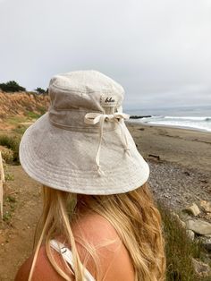 "A sun hat for beach days and summer fun. This sun hat for women has a nice wide brim to protect your whole face and even your neck and chest. A drawstring around the head keeps the hat fitting snug. Easy to bring along in your bag, folds up easy. This hat is made from a medium weight homespun linen and cotton blend fabric in a neutral beige color. Inside liner is white cotton. I used a stiff interfacing for brim to keep it's shape. Brim measures 4.5\" Crown depth is 3.5\". Contact me for custom Cute Sun Hat, Summer Hats For Women 2024, Adjustable Beach Hat, Sunhat Aesthetic, Coastal Hats, Beach Hat Aesthetic, Wide Brim Hat Outfit, Summer Hat Style, Hat For Beach