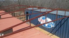 an old pepsi sign is on the side of a shipping container that has been painted red and blue