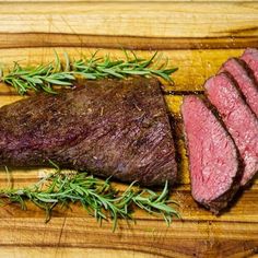 a piece of steak on a wooden cutting board